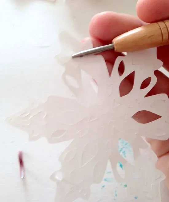 Punching the chads out of paper snowflakes