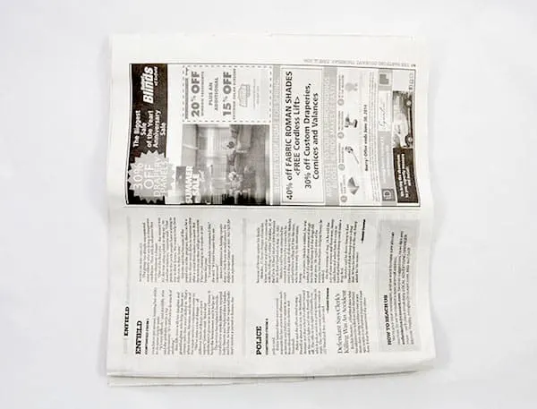 Spread out sheet of newspaper