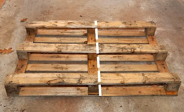 Pallet laying on the ground with a line showing where to cut it