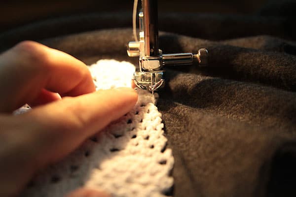 Sewing a doily onto the front of a t-shirt with a sewing machine