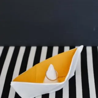 DIY ring holder on a black and white striped surface