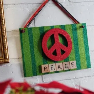 This holiday sign uses some of my favorite craft supplies - scrabble tiles, glitters, and the peace symbol. It's the perfect holiday display!