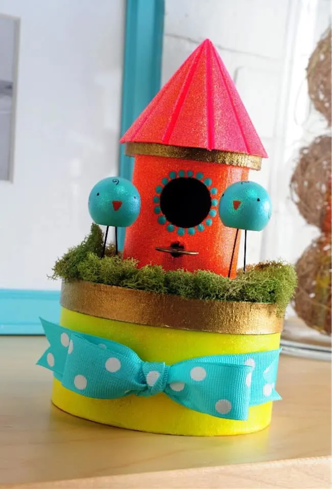This DIY birdhouse project is so perfect for spring! Decorate the top of a box with bright colors and glitters, and store goodies inside.