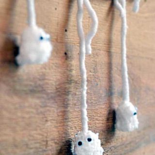 These delightful pom pom ghosts with googly eyes are the cutest of Halloween kids crafts - and so easy to make!