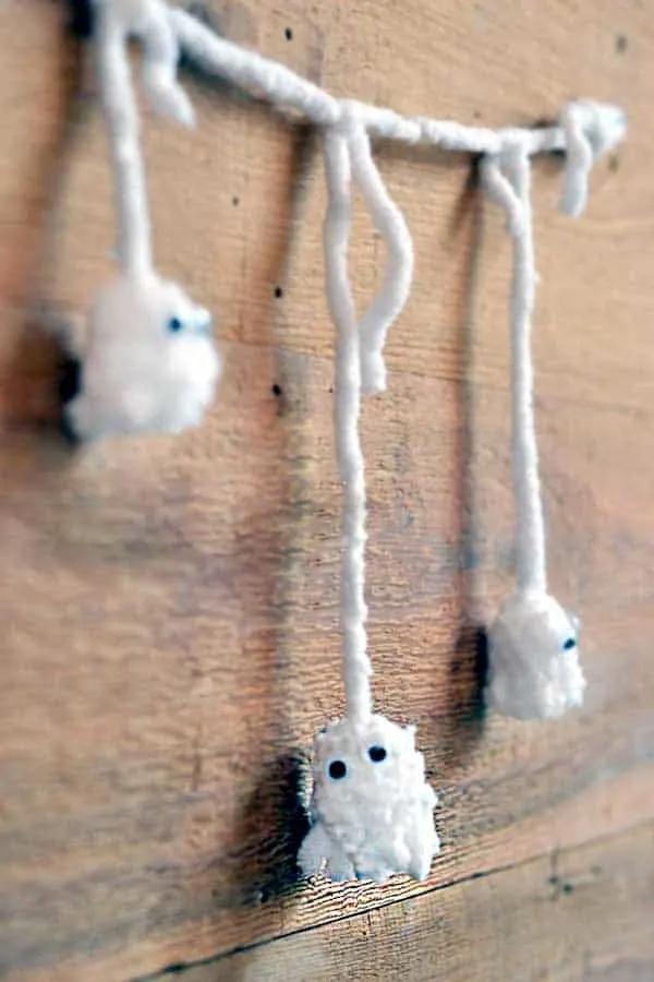 These delightful pom pom ghosts with googly eyes are the cutest of Halloween kids crafts - and so easy to make!
