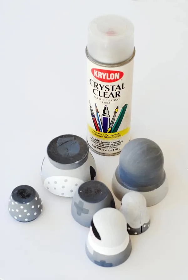 Applying a coat of clear acrylic to nesting dolls