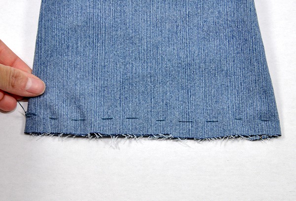 Denim hand stitched approximately 1/2" above the edge