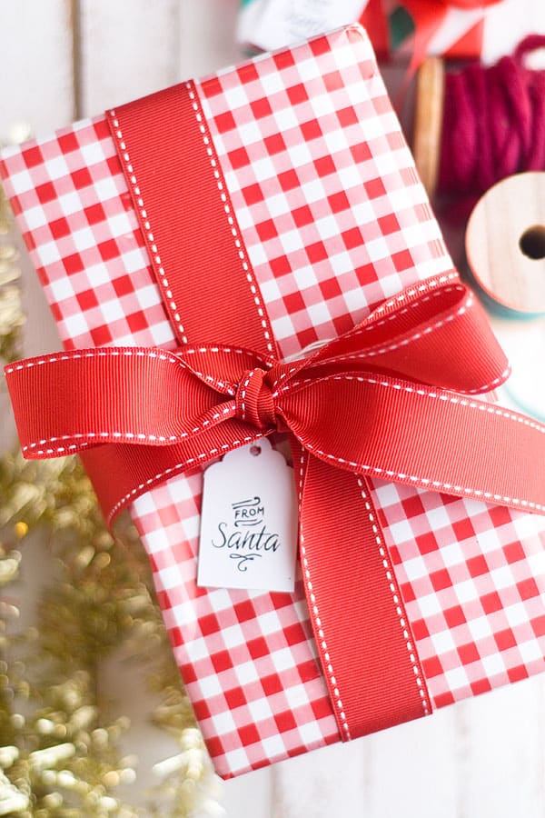 From Santa tag on a red plaid package wrapped with red ribbon