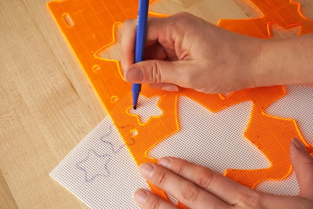 Tracing stars on the plastic canvas with a washable marker