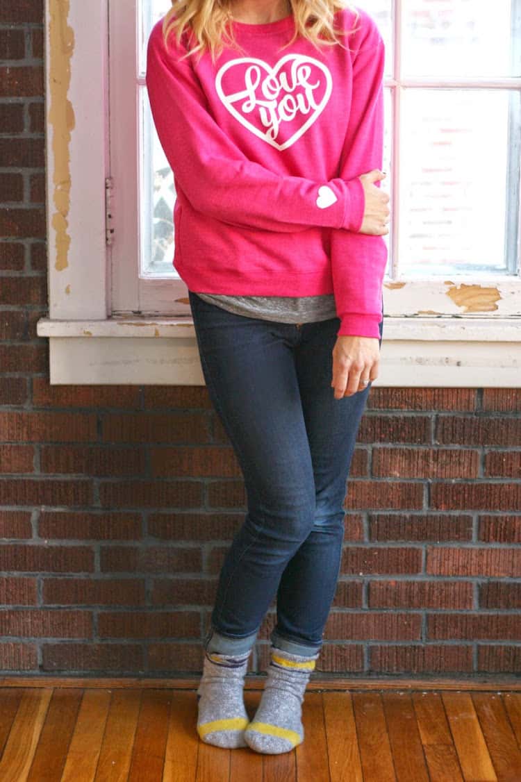 Woman wearing a DIY Valentine's Day sweatshirt that says Love You on the front
