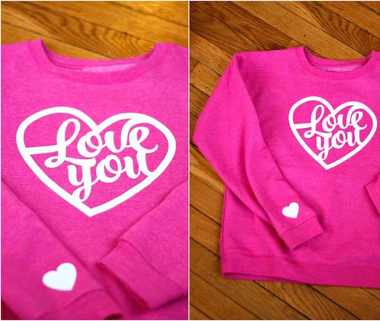 Love you heart sweatshirt laying out and showing the heart on the sleeve
