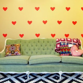 DIY temporary wall decals with a green couch and a black and white rug