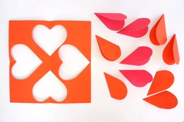 Hearts cut out of orange and pink paper