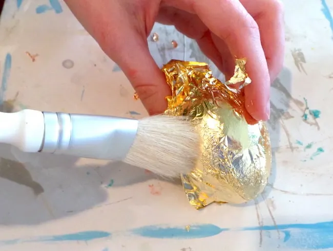 Add gold leaf to a painted wood Easter egg