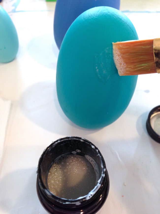 Add gold leaf sizing to a painted wood Easter egg