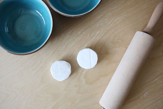 Air dry clay circles about to be rolled out with a rolling pin