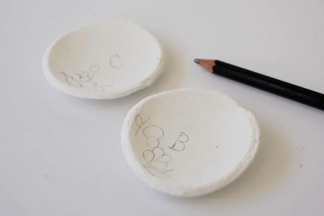 Floral patterns drawn onto the dishes with a pencil