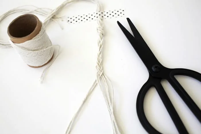 Braided twine taped down with a pair of scissors