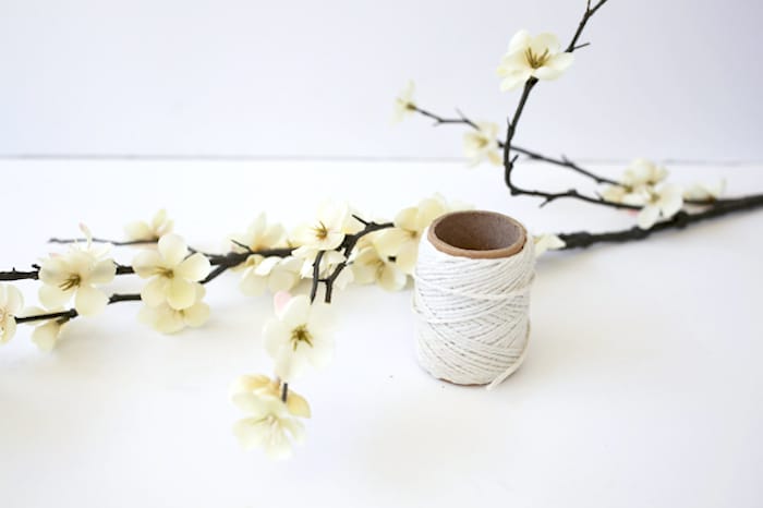 Faux flowers on a branch and roll of twine