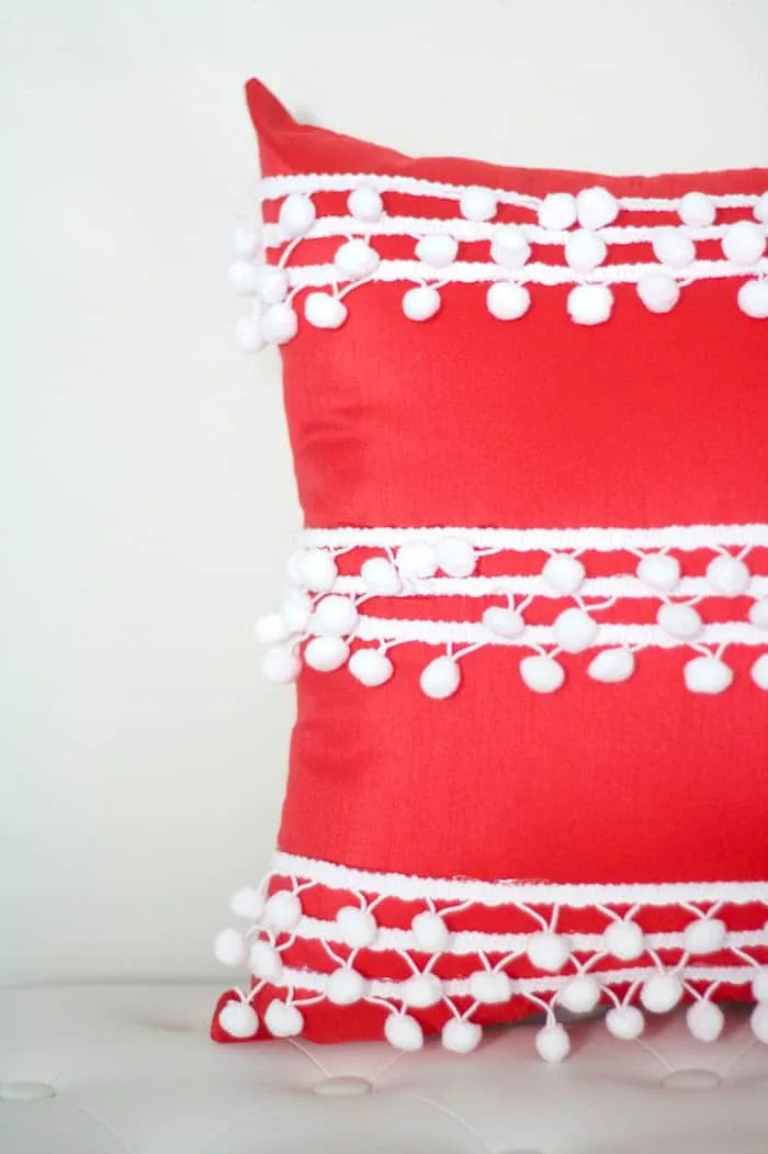 DIY pom pom pillow red cover with pom pom trim attached