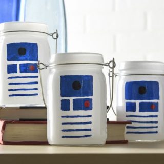 This Star Wars craft is SO easy to make! I used dollar votives and paint pens to celebrate my love of R2D2 and create some cool luminaries.