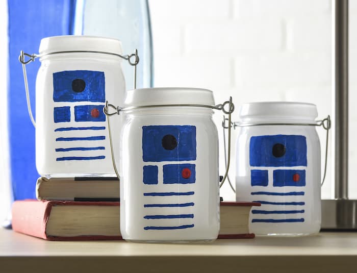 This Star Wars craft is SO easy to make! I used dollar votives and paint pens to celebrate my love of R2D2 and create some cool luminaries.
