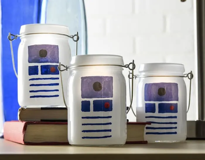This Star Wars craft is SO easy to make! I used dollar votives and paint pens to celebrate my love of R2D2 and create some cool luminaries.