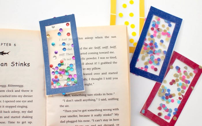 Make your own bookmark with paint chips, clear contact paper, and confetti