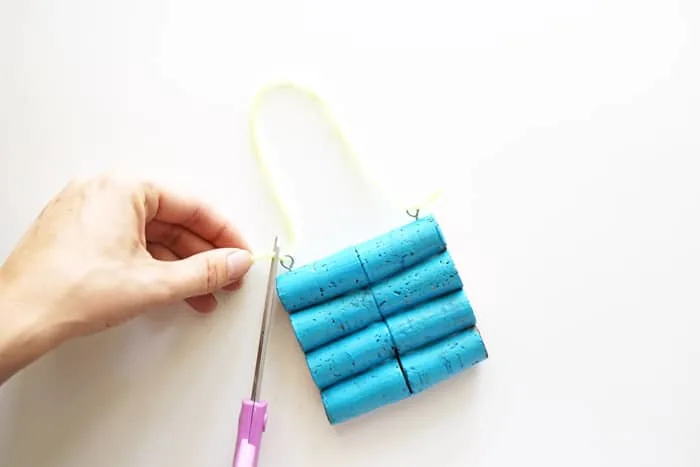 Trimming yarn with a pair of scissors