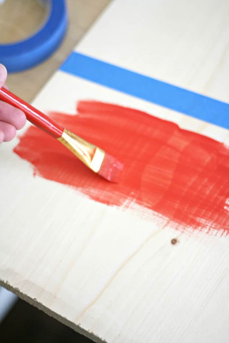 Painting the wood with light red paint
