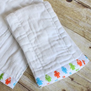 Use cloth diapers to make baby burp cloths that are a perfect gift for a new mom. This is such an easy DIY - and can be customized for boy or girl.