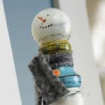 Grab a wood spindle from the hardware store or a construction site and turn it into this unique snowman craft. It's the perfect seasonal display piece!