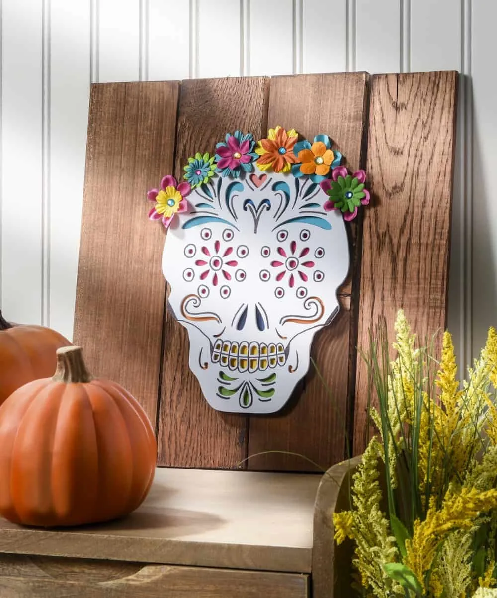 This unique calavera (skull) art was made using a recycled pallet. Perfect for Dia de Los Muertos, but you can keep it up all year!