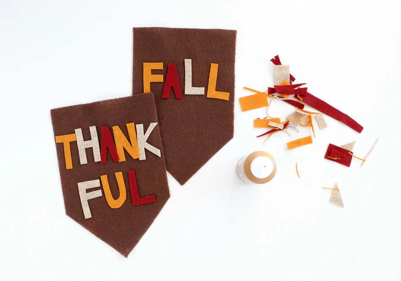 Felt letters spelling thankful and fall glue to brown pieces of felt