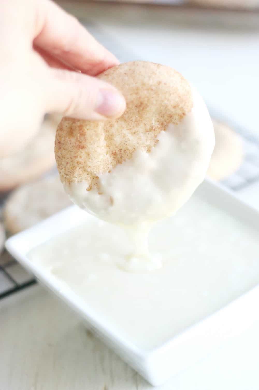 Dipping a snickerdoodle cookie into white chocolate