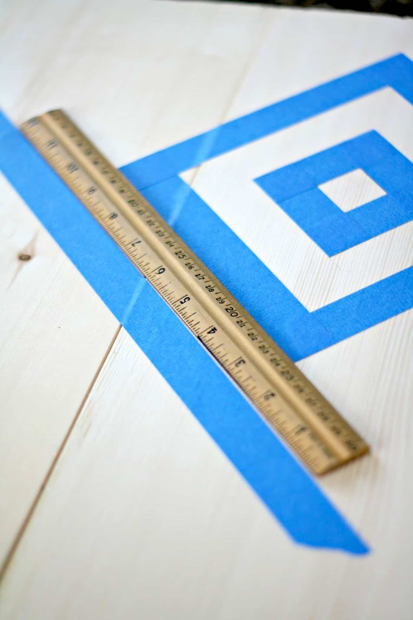 Making squares on a wood panel using painter's tape and a ruler