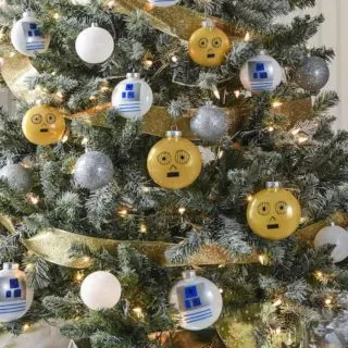 Rebels will love this droid themed Star Wars Christmas tree! Learn how to easily DIY your own C-3PO and R2-D2 ornaments. Your family will love these decorations and having the Force in their home during the holidays.