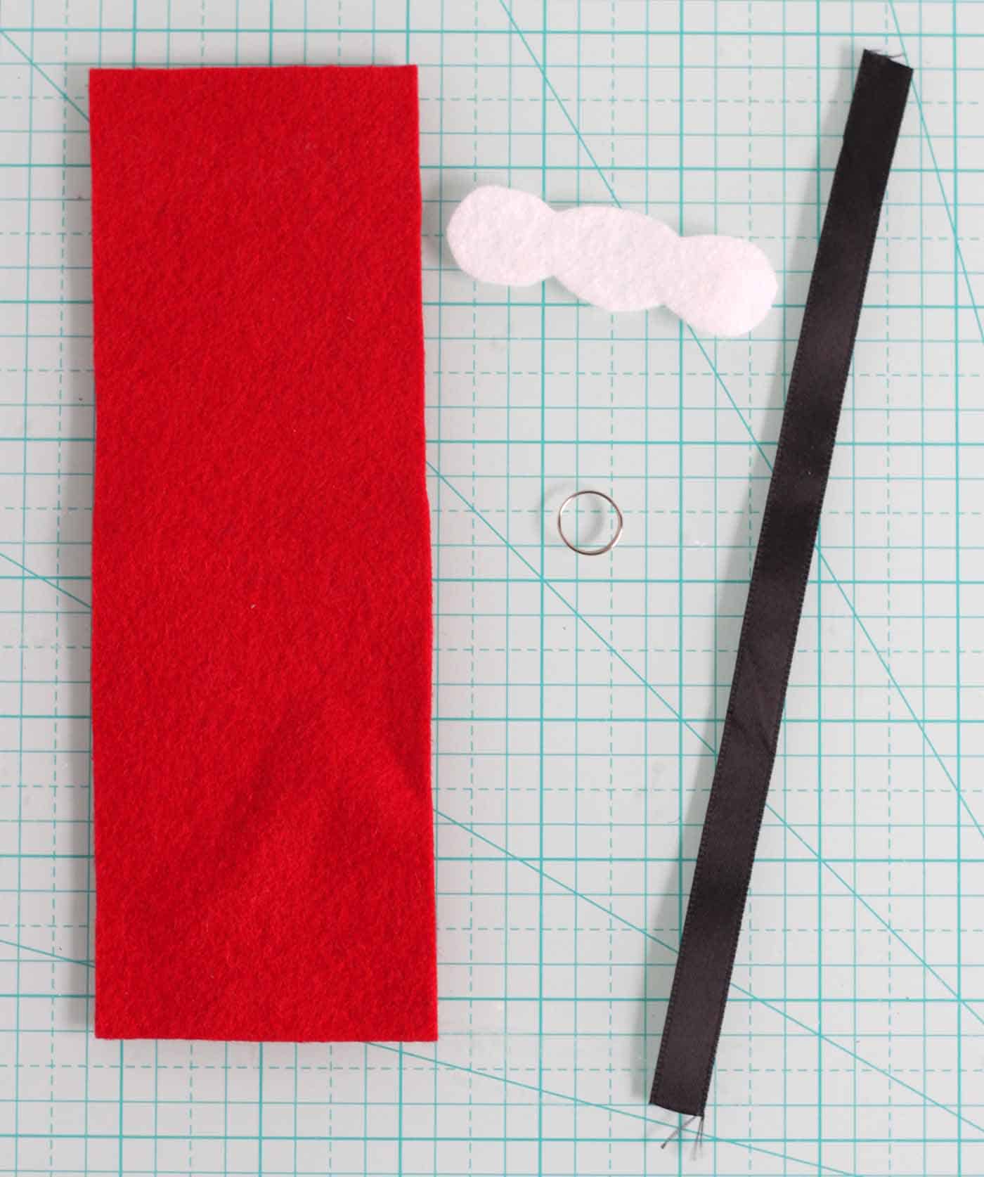 Red felt, white felt piece, split ring, and black satin ribbon
