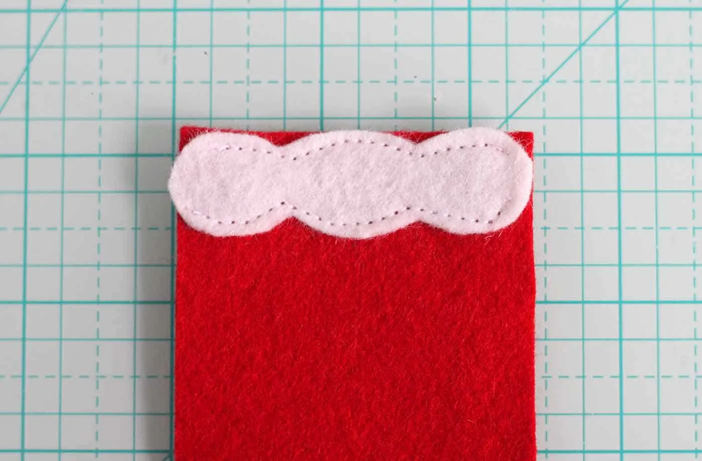 White felt sewn to one end of the red felt