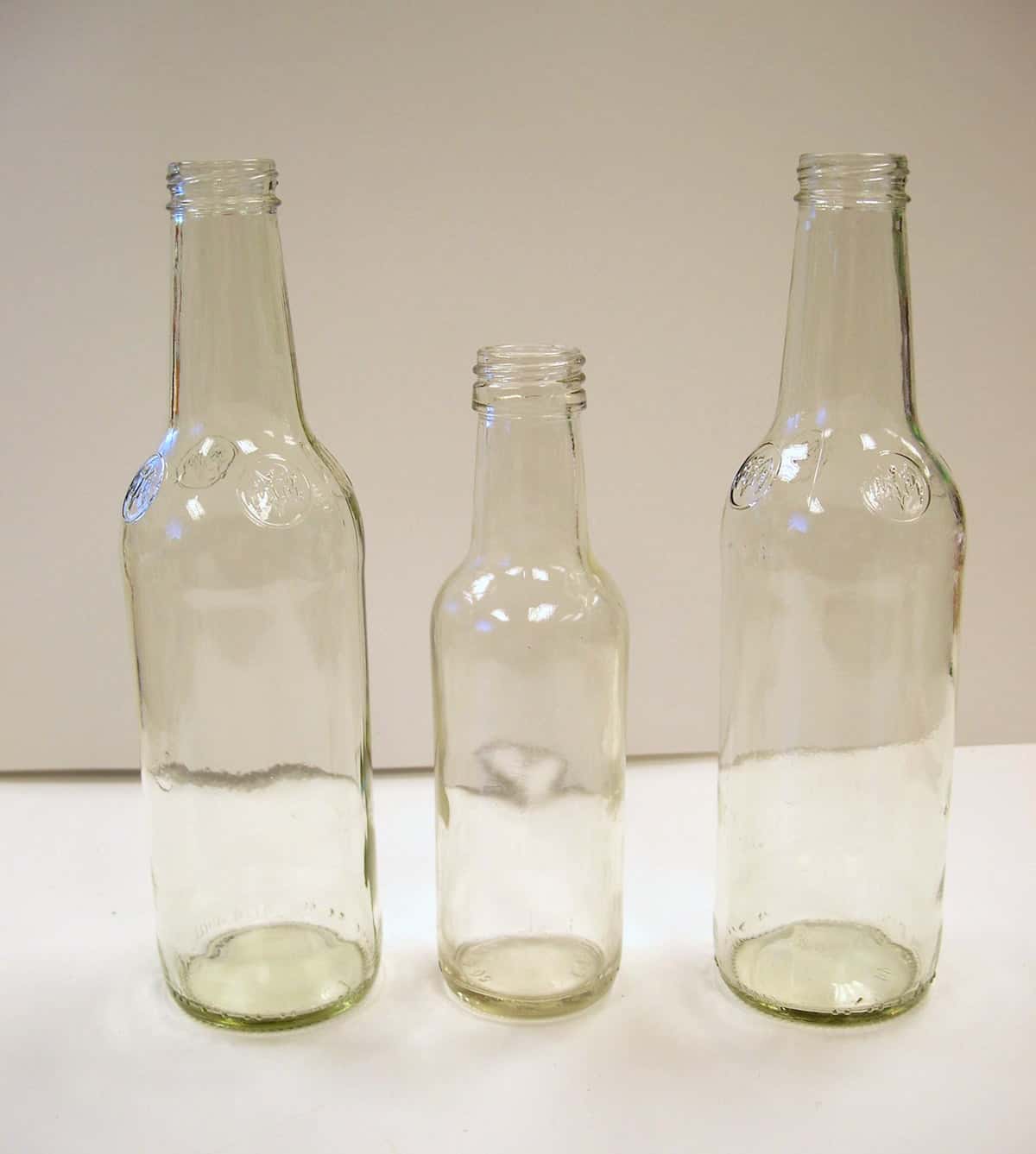 Three clear glass bottles
