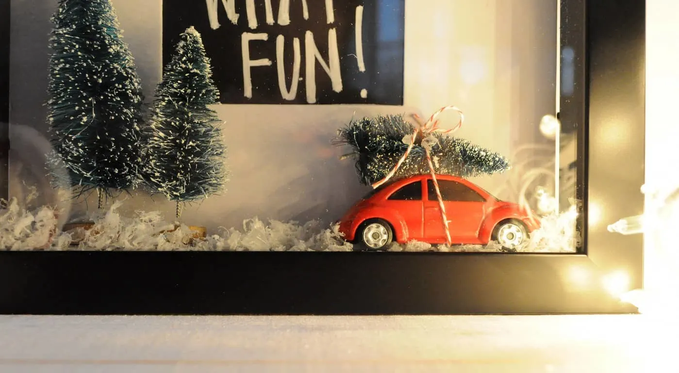 This DIY Christmas shadow box is a fun take on the festive snow globe trend! It incorporates one of the season's most popular trends: trees on cars. 