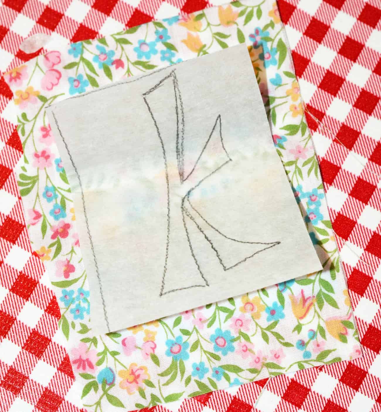 Letter K on a sheet of steam a seam paper on top of fabric