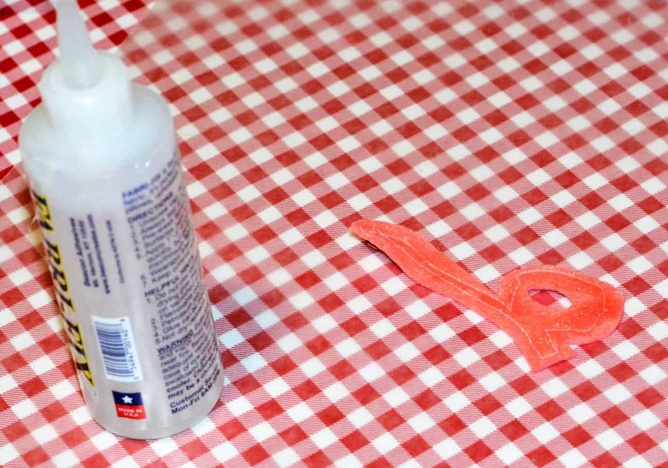 Bottle of fabric glue and a fabric letter