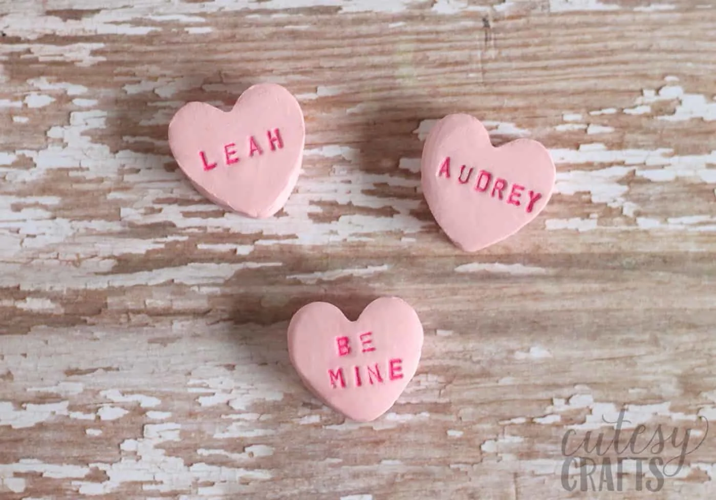 Finished clay hearts that say "Leah," "Audrey," and "Be Mine"