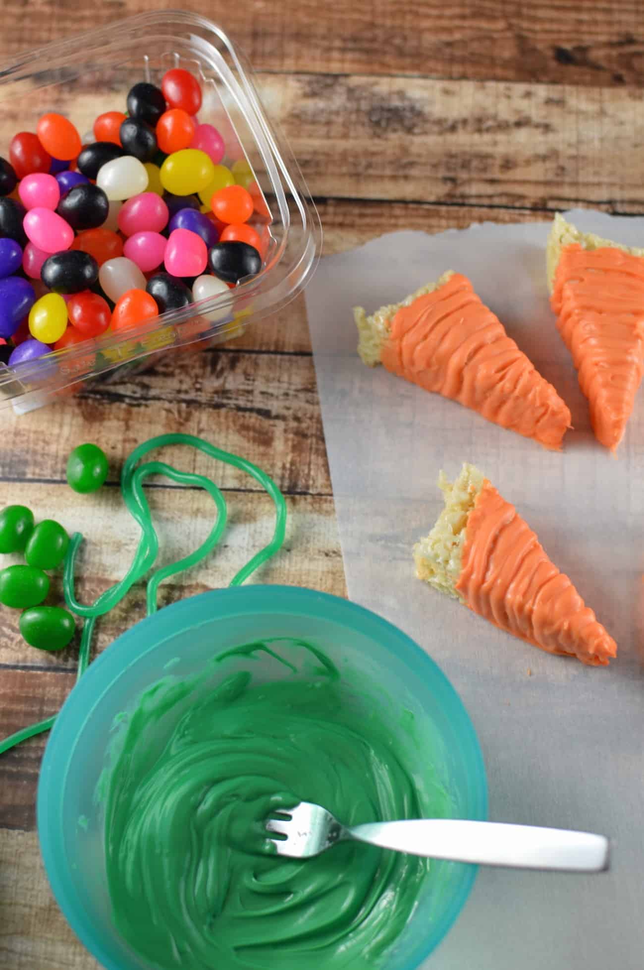 Green candy melts melted a bowl with a fork inside