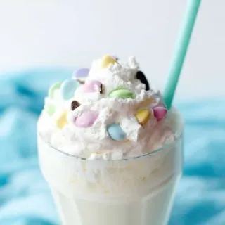 Celebrate the holidays (or any time of year) with this delicious banana milkshake! Whipped cream, Peeps and M&Ms on top make it extra festive.