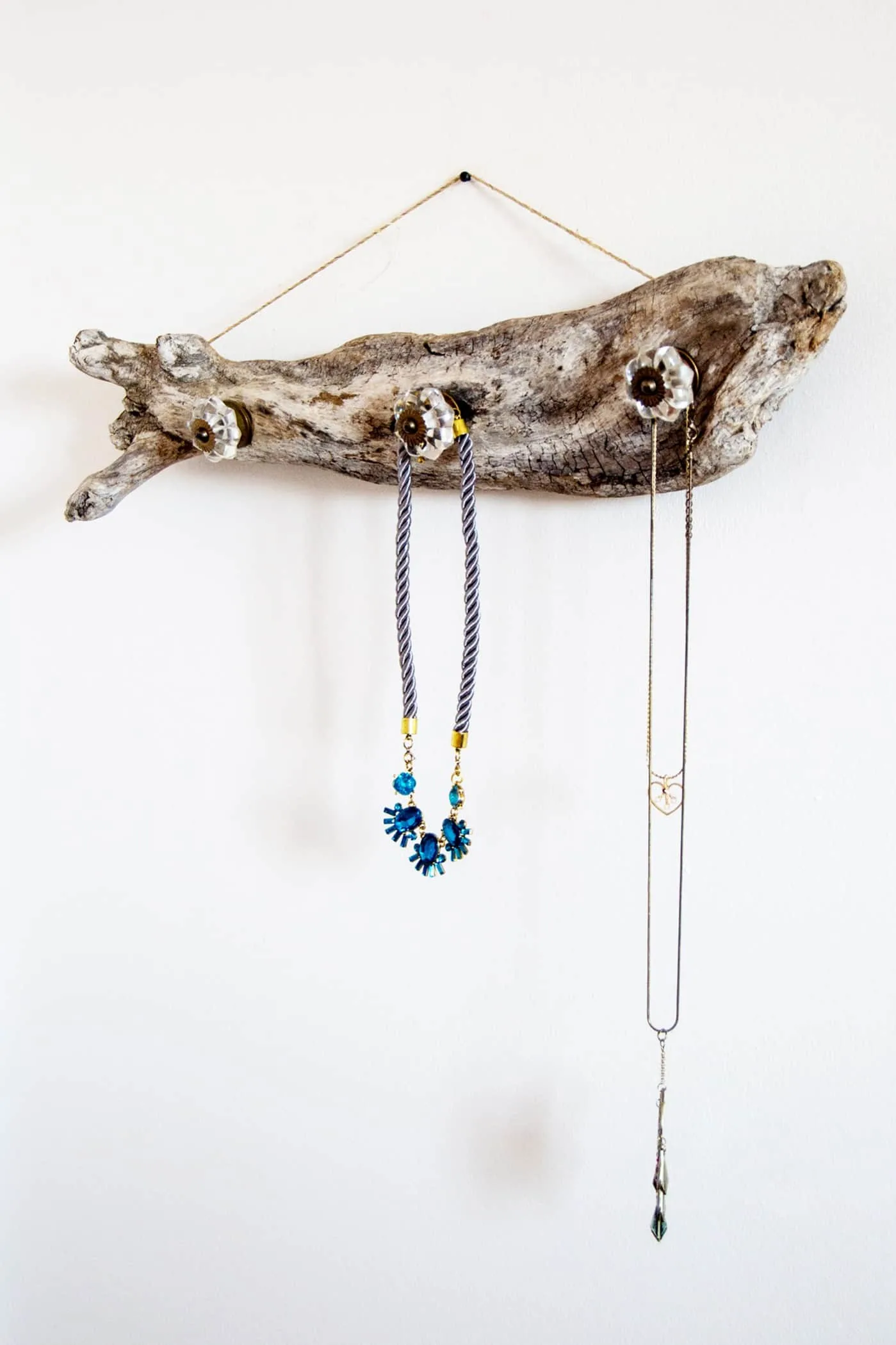 Use a gorgeous driftwood piece to create a unique jewelry hanger. It looks great on the wall whether you have jewelry on it or not, and it's easy to make!