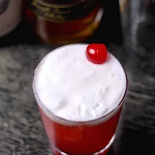 cherry juice cocktail with egg white foam