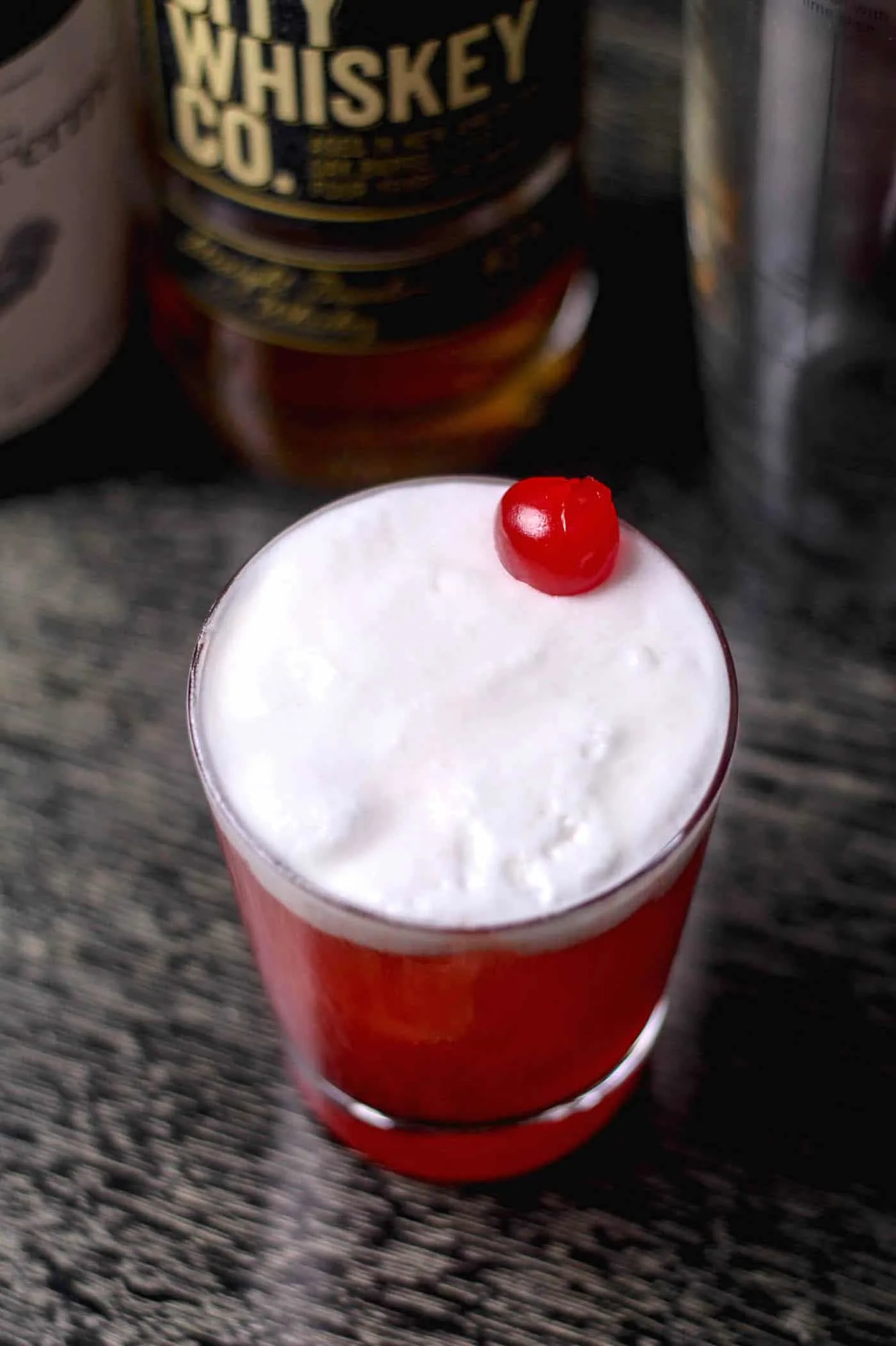 cherry juice cocktail with egg white foam