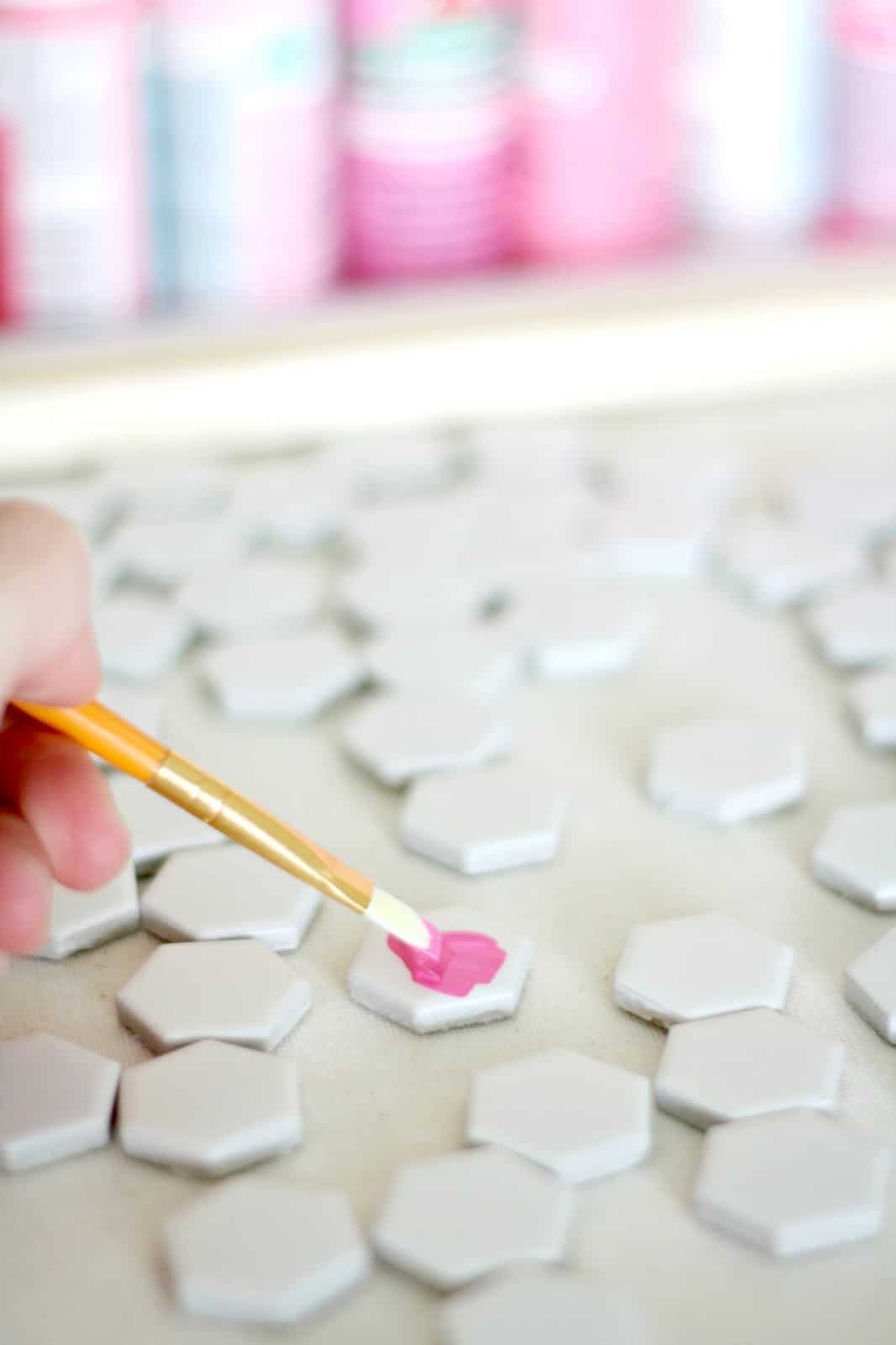Painting hexagon tiles with pink craft paint